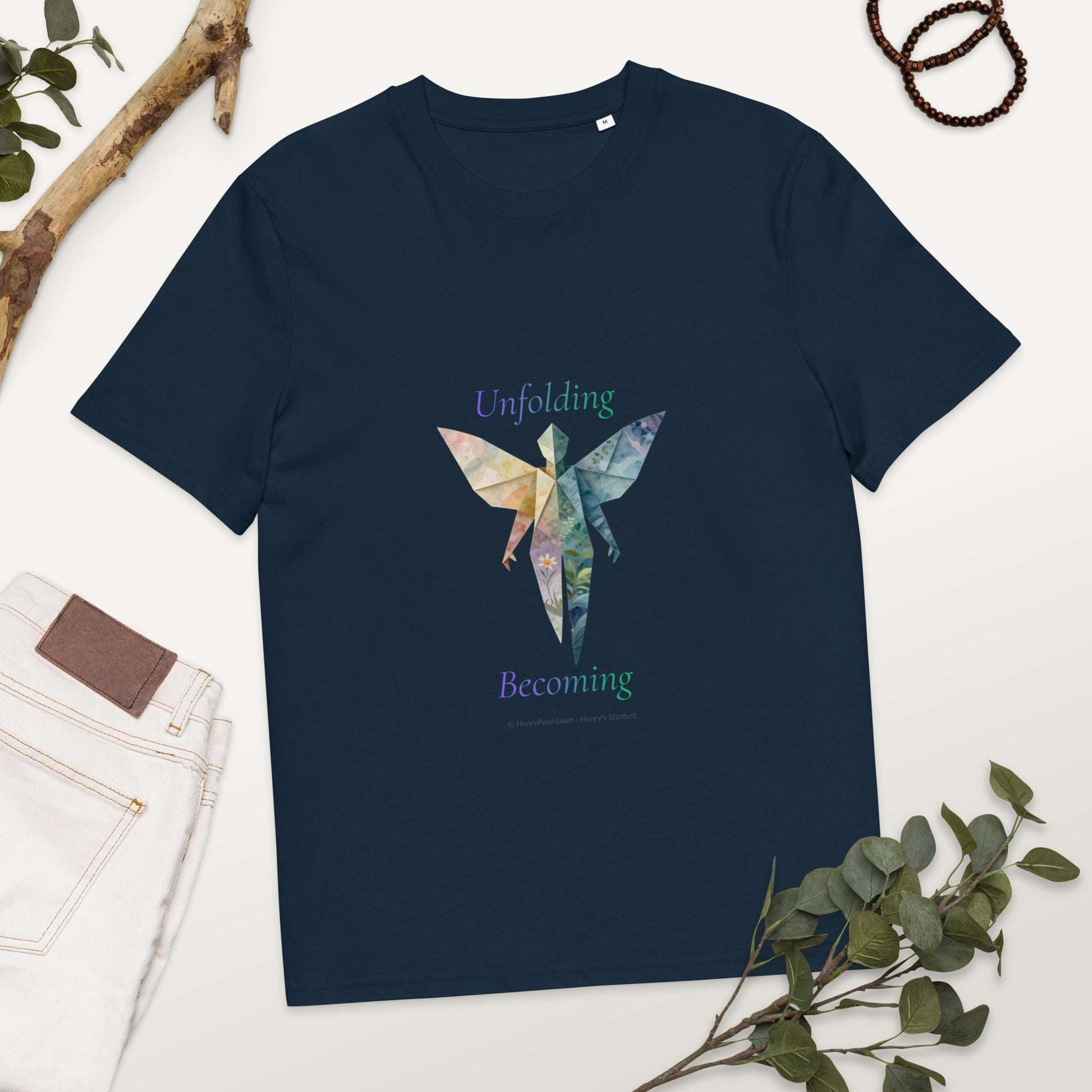 BOMBY Unfolding origamis silhouette Organic Cotton T-Shirt in navy blue featuring colorful origami-style butterfly silhouette and 'Unfolding Becoming' text.