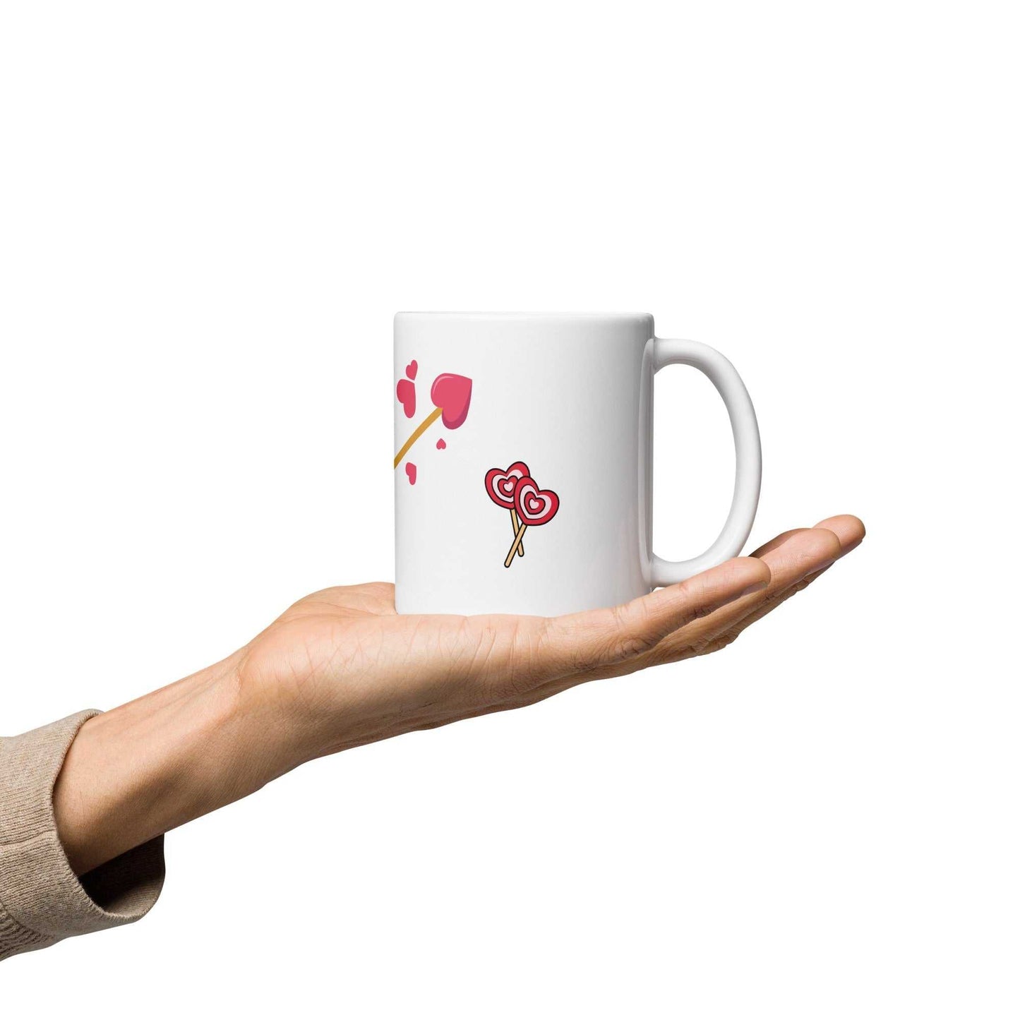 Hand holding Valentine mug gift featuring heart-shaped lollipops and arrow, perfect for romantic coffee or tea moments.