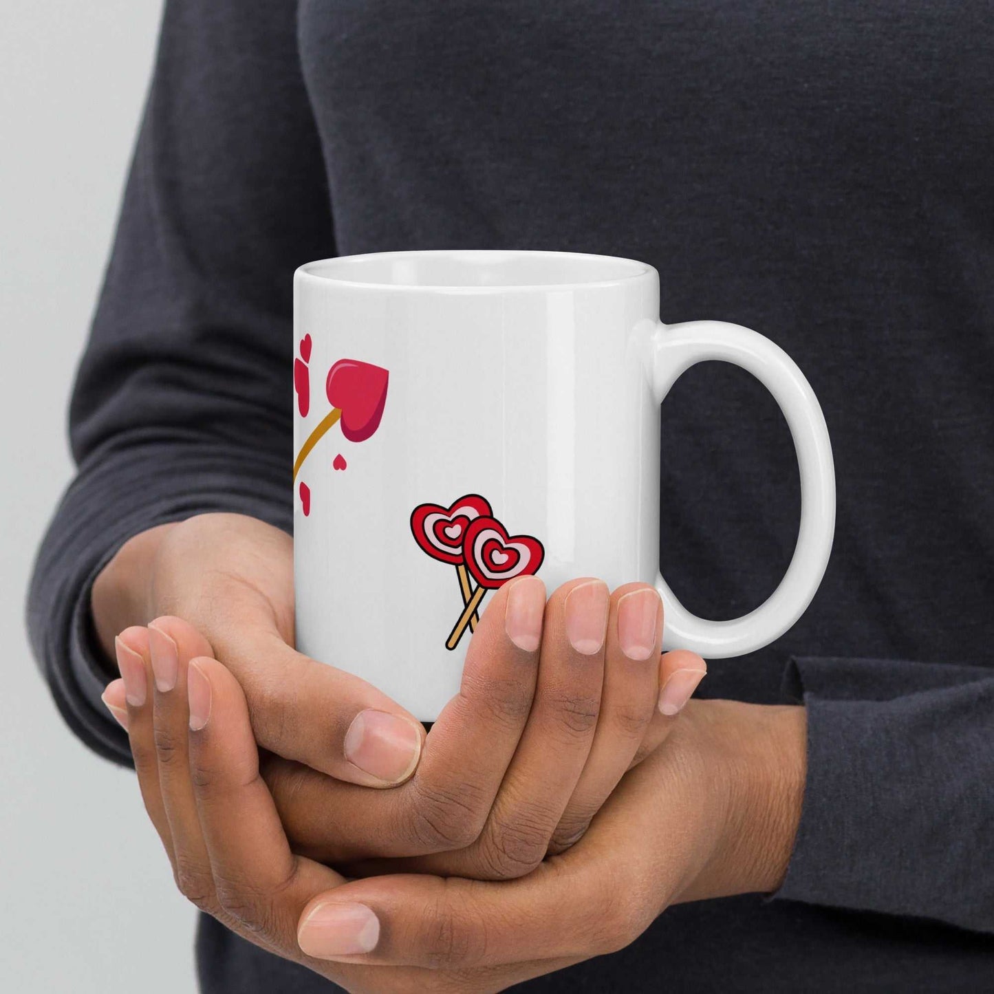 Valentine mug gift with pink bird and heart arrow design held in hands, ideal for cozy coffee moments or Valentine's Day.