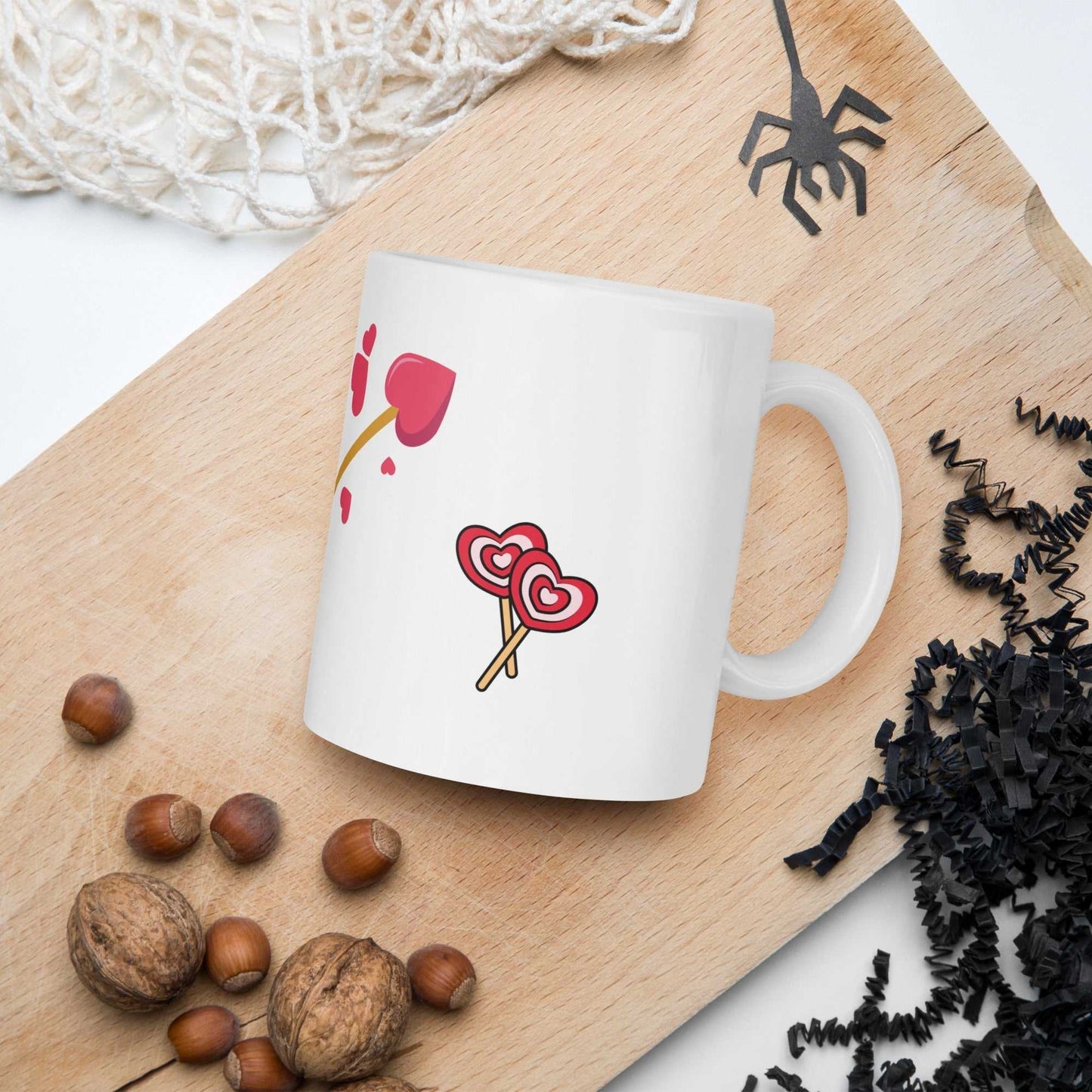 Valentine mug gift with heart lollipops and arrow design placed on a wooden tray, ideal for cozy kitchen or dining decor.