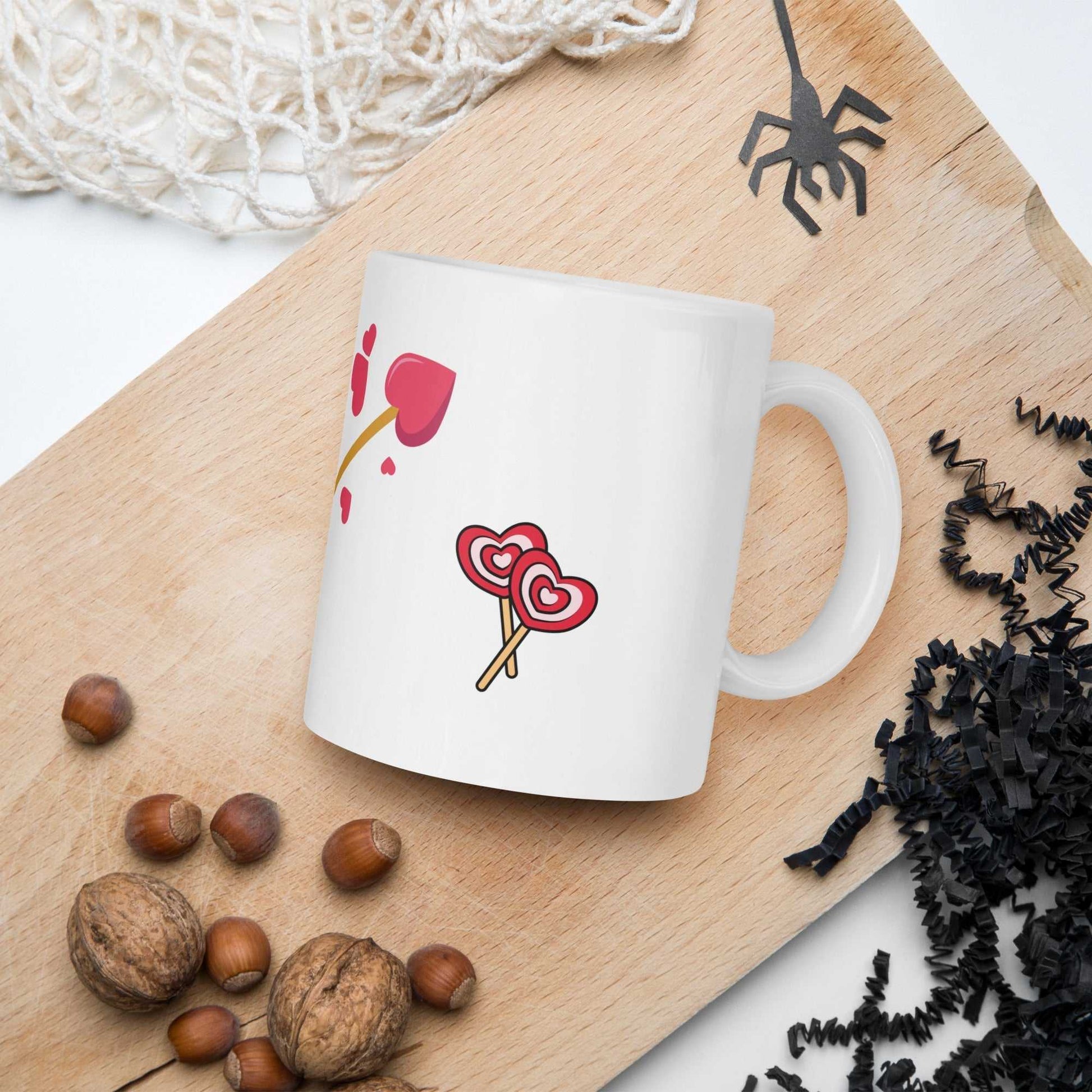 Valentine mug gift with heart lollipops and arrow design placed on a wooden tray, ideal for cozy kitchen or dining decor.