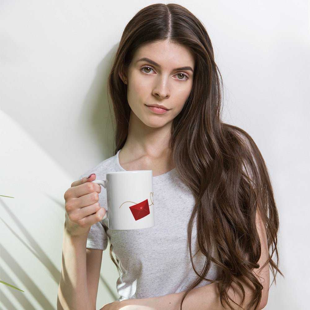 Valentine Mug - Envelope & Hearts gift held by woman, ceramic 11 oz mug with red envelope design, perfect for romantic coffee moments.