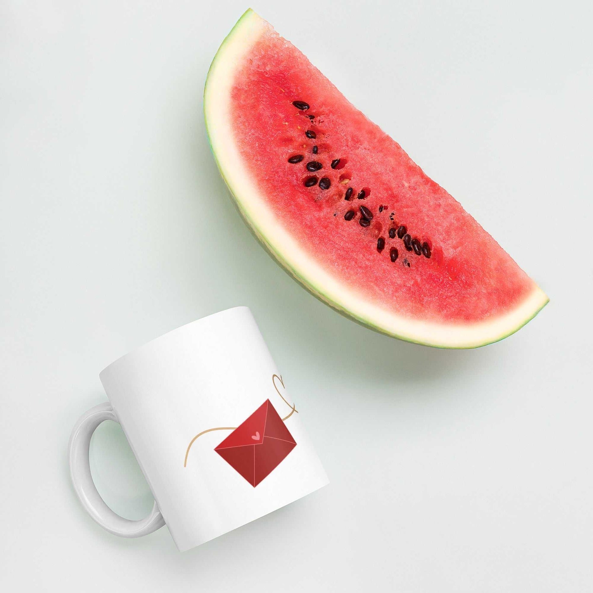 Valentine Mug - Envelope & Hearts gift beside watermelon slice, ceramic 11 oz, red envelope design, playful and romantic mug.