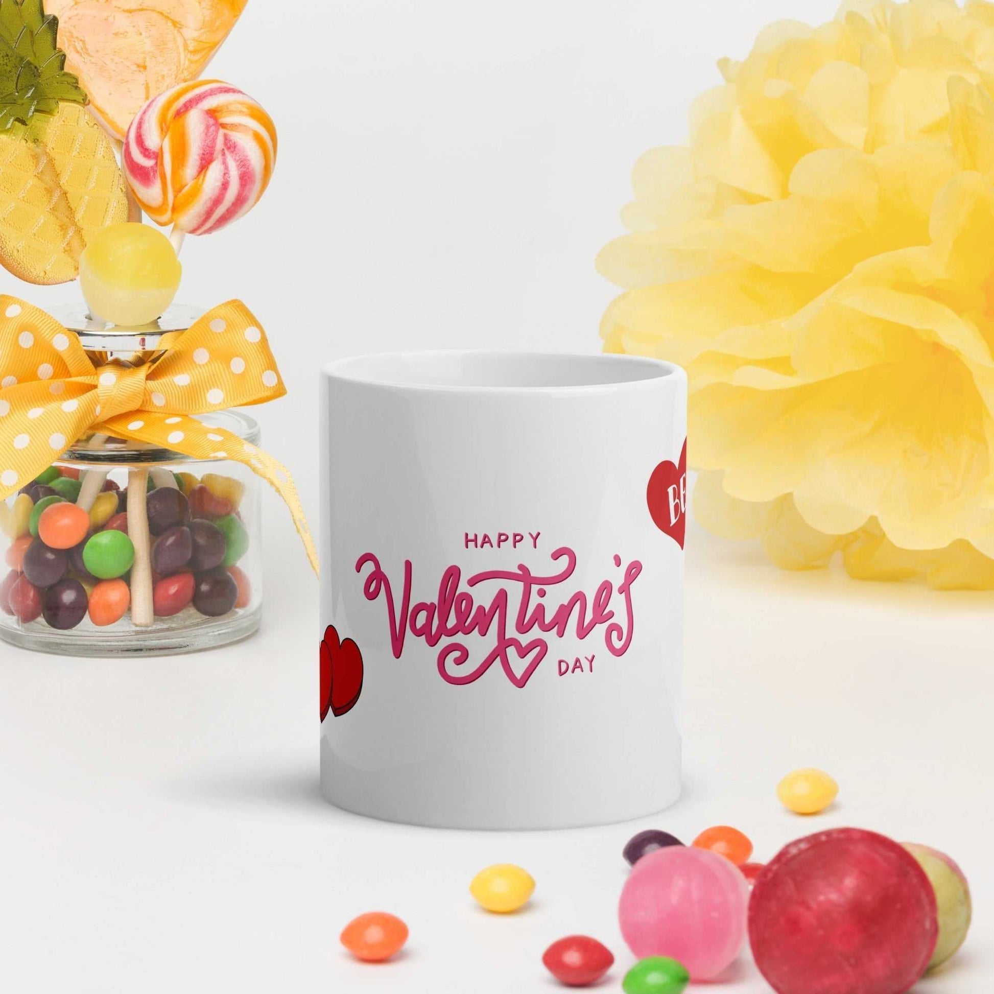 Valentine Mug - valentine mug | 11oz ceramic drinkware with pink Valentine's Day text, styled with candy and yellow festive decor.