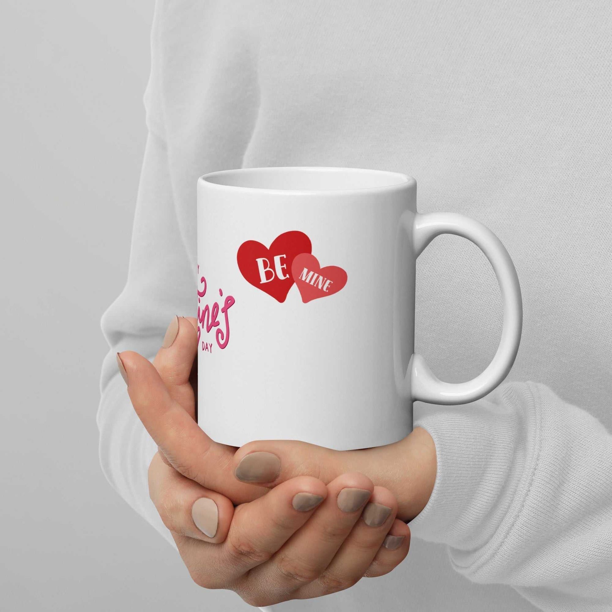 Valentine Mug - valentine mug | 11oz ceramic drinkware with 'Be Mine' heart graphic, held in hands, great for Valentine's Day gifts.