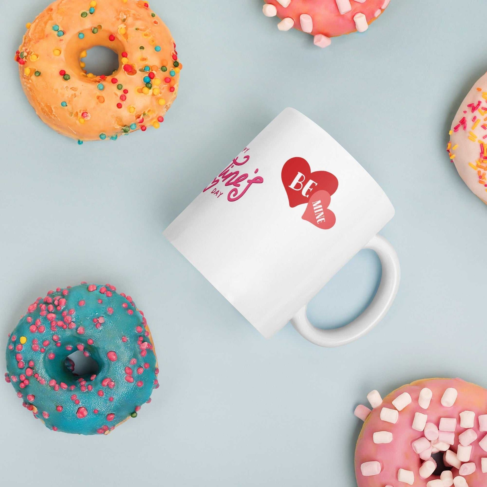Valentine Mug - valentine mug | 11oz ceramic drinkware with heart design, styled with colorful donuts, perfect for festive gifting.