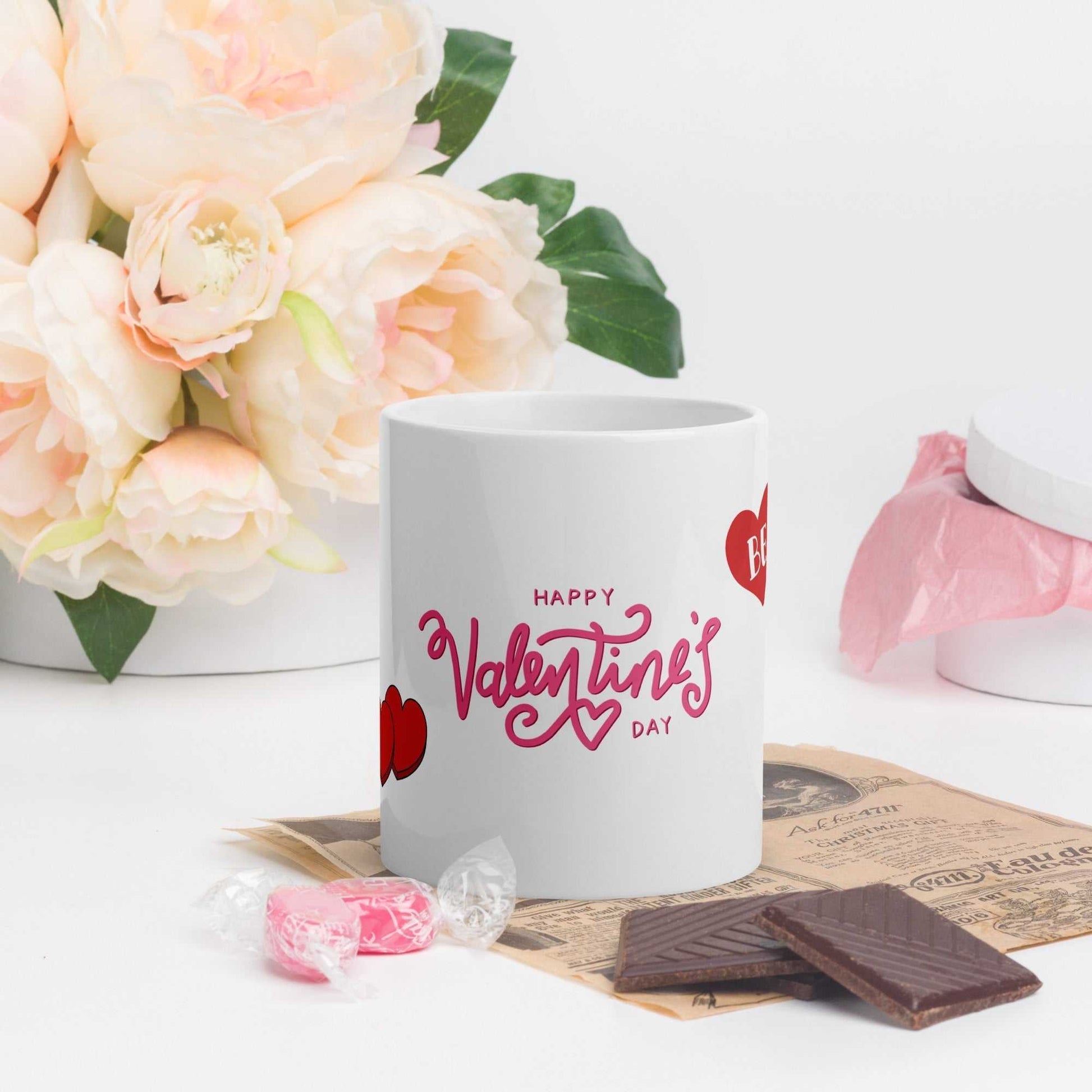 Valentine Mug - valentine mug | 11oz ceramic drinkware with pink Happy Valentine's Day text, styled with flowers and sweets.