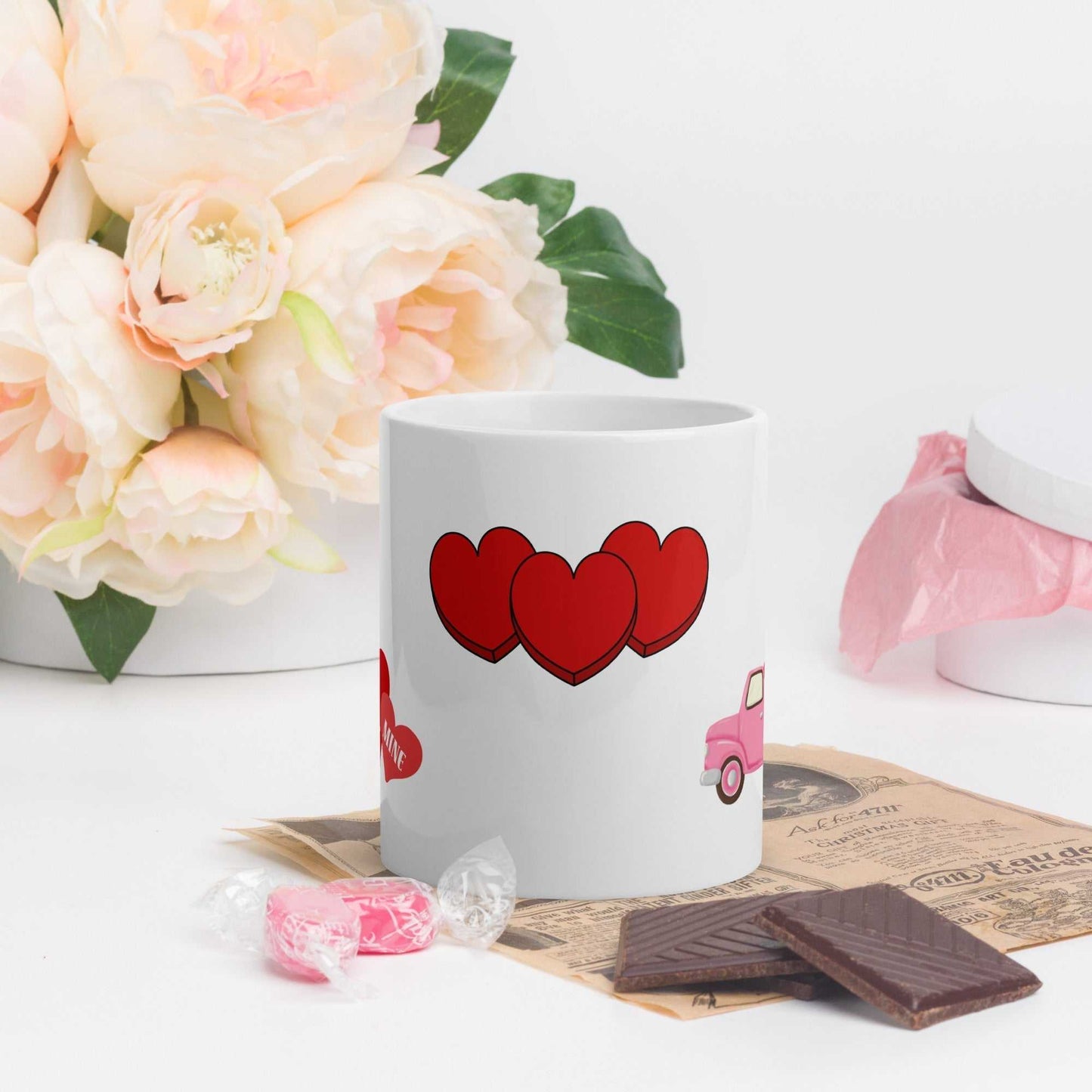 Ceramic Valentine mug with triple heart design, styled with chocolates and floral decor, perfect for gifting or daily use.