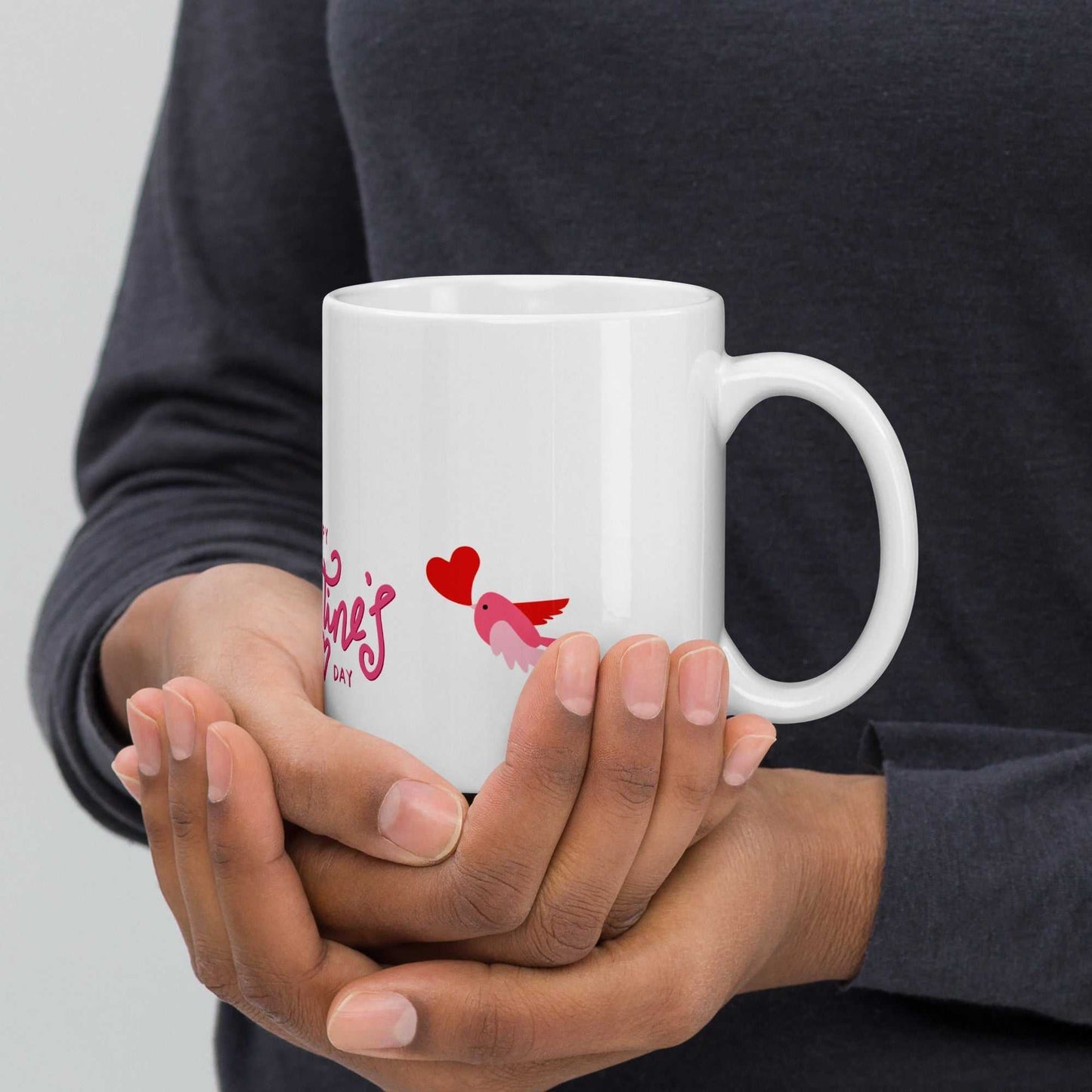 Valentine Mug Ceramic with pink bird and heart, 11oz mug held in hands, perfect for cozy Valentine's Day moments and gifting.