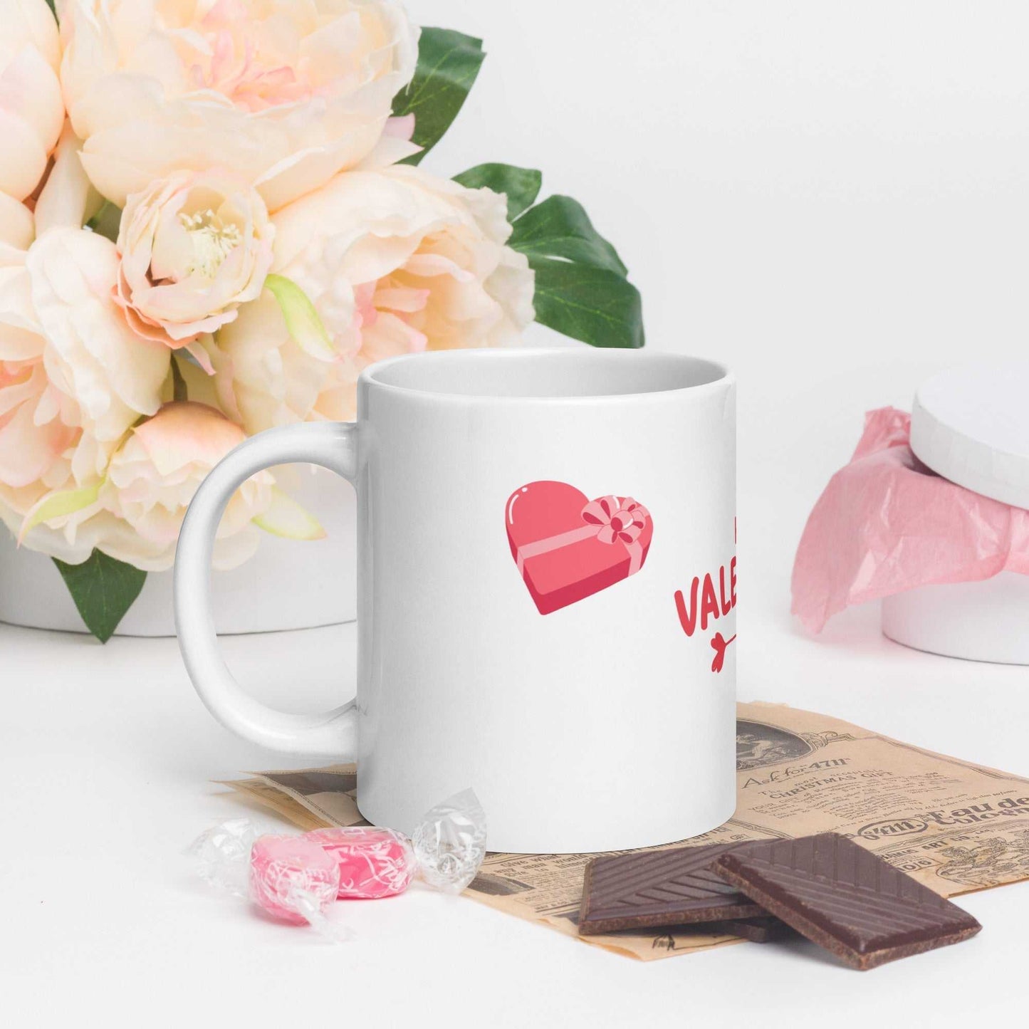 Heart gift design on ceramic valentine mug, styled with sweets and flowers; ideal for romantic gifting.