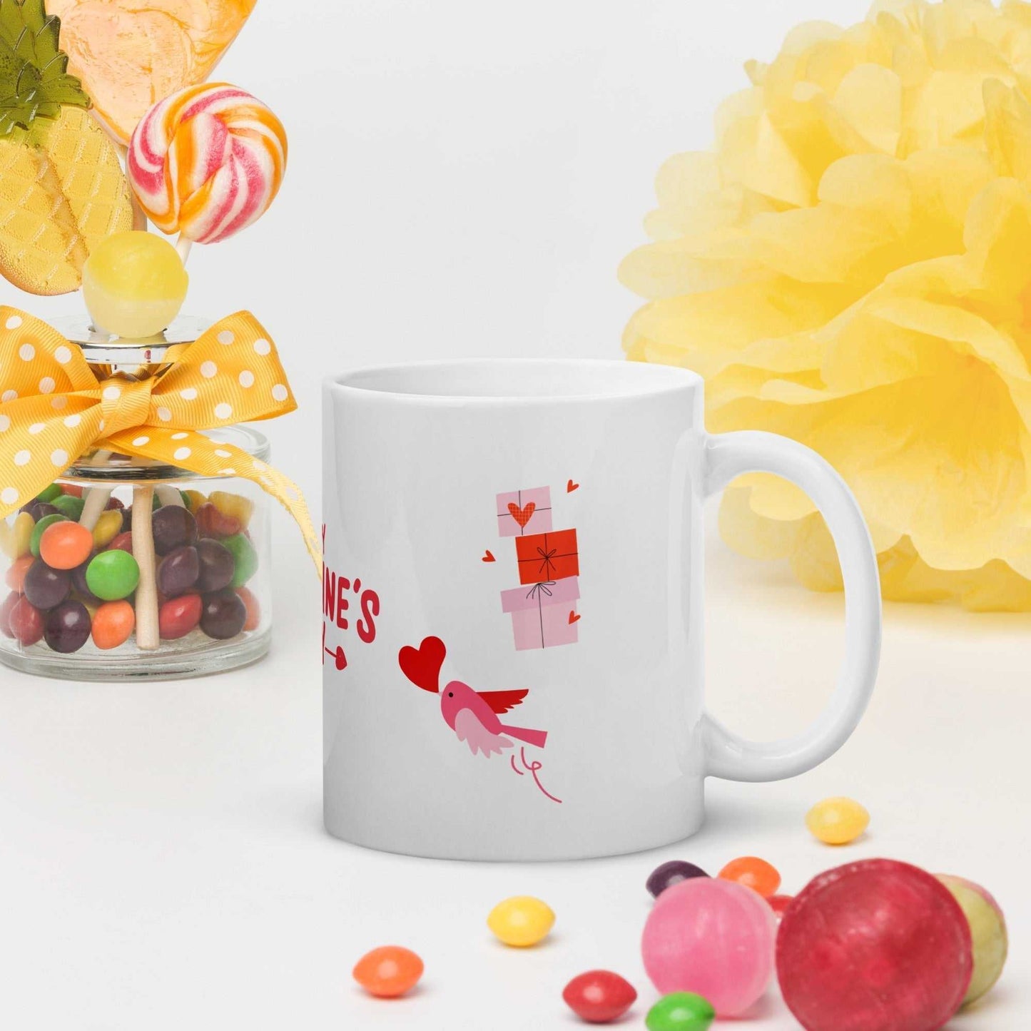 Valentine mug gift with little bird, red hearts, and gift boxes design. Ceramic, dishwasher safe mug in a festive candy-themed setup.