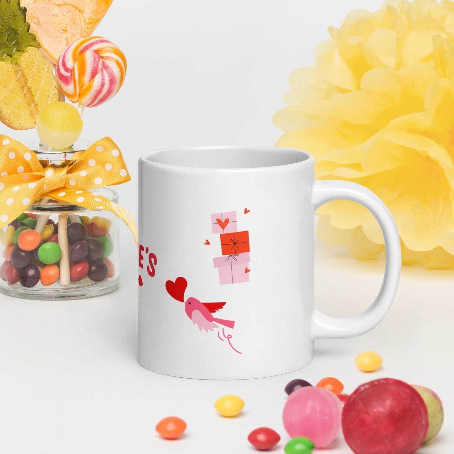 Little bird carrying a heart with stacked gift boxes on valentine mug. Cute and festive ceramic mug for Valentine's Day celebrations.