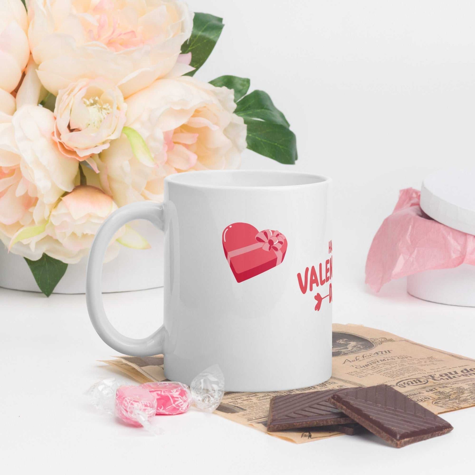 Valentine mug with heart gift design, styled with chocolates and flowers; romantic gift idea for coffee lovers.