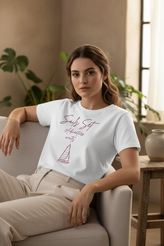 White t-shirt with pink sailboat graphic and text on a white background