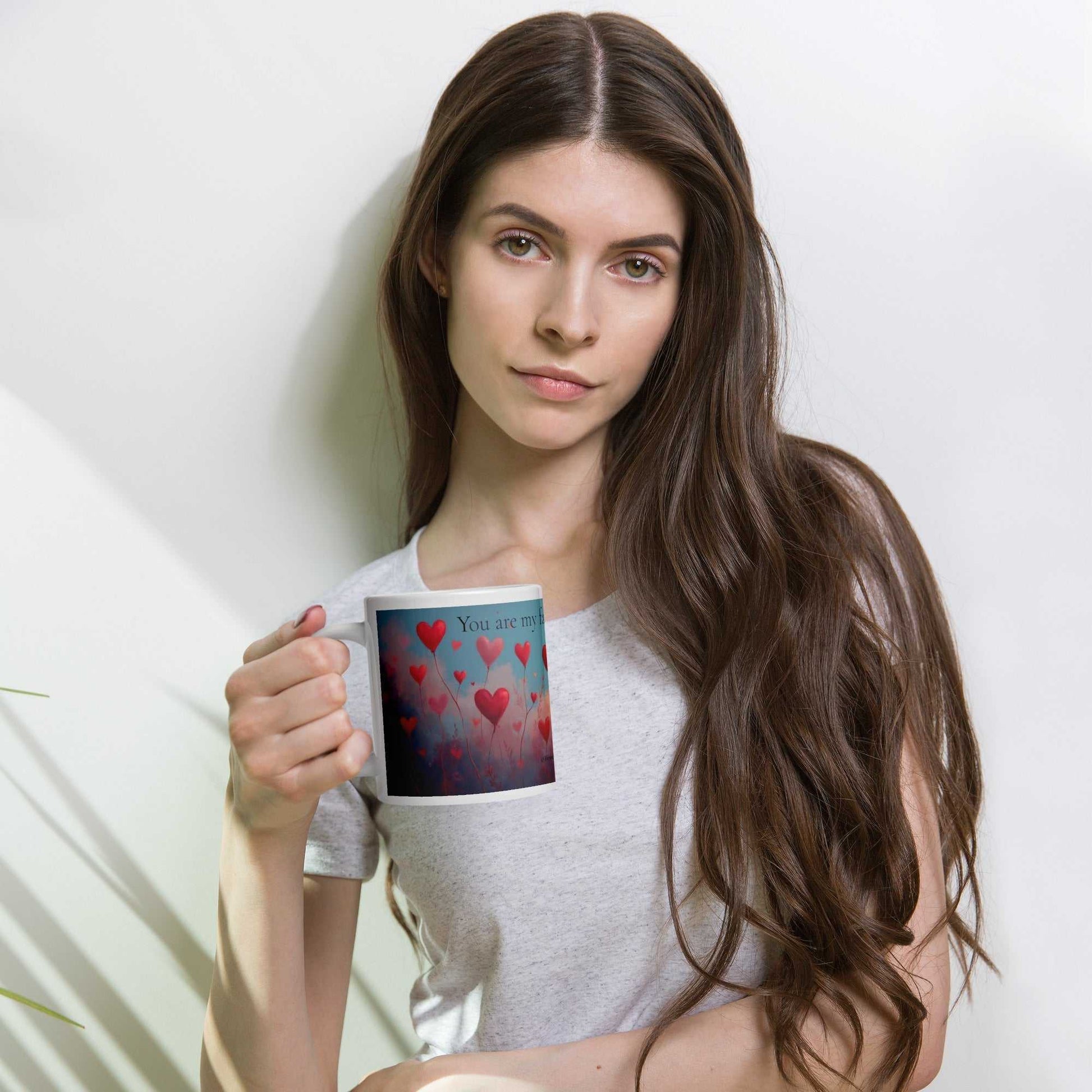 Woman holding You are my favourite Valentine mug gift, highlighting the romantic 20oz drinkware with red heart design for loved ones.